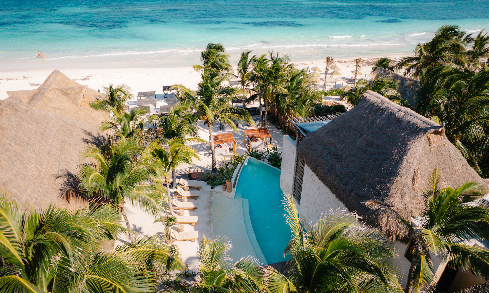 Maxanab hotel on tulum beach with ocean and coconut palms