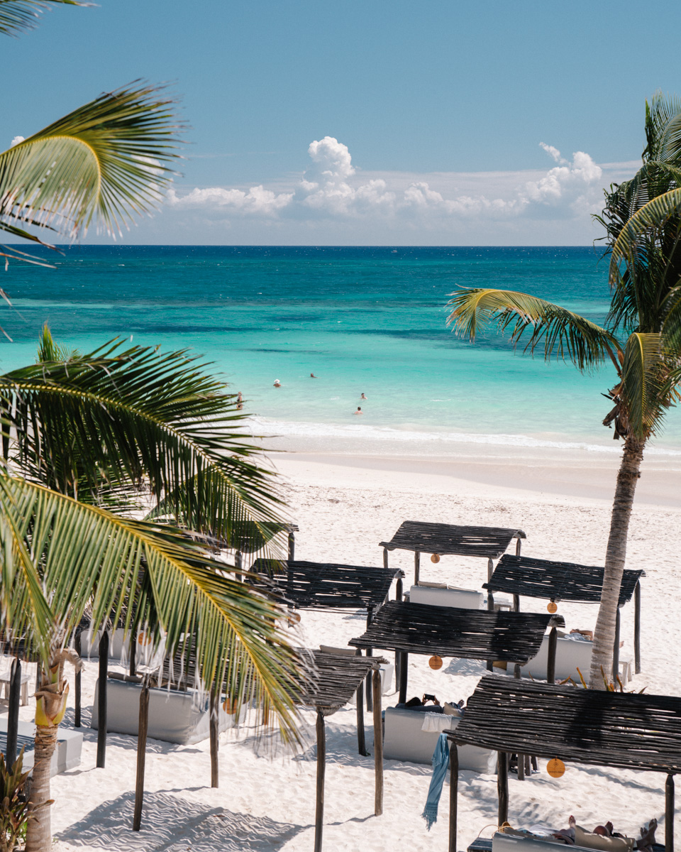 maxanab hotel beach cabanas under palm trees at tulum beach