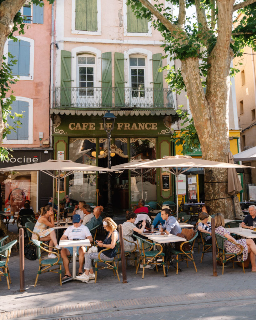 cafe street scene in summer in L’Isle sur la Sorgue, provence france
