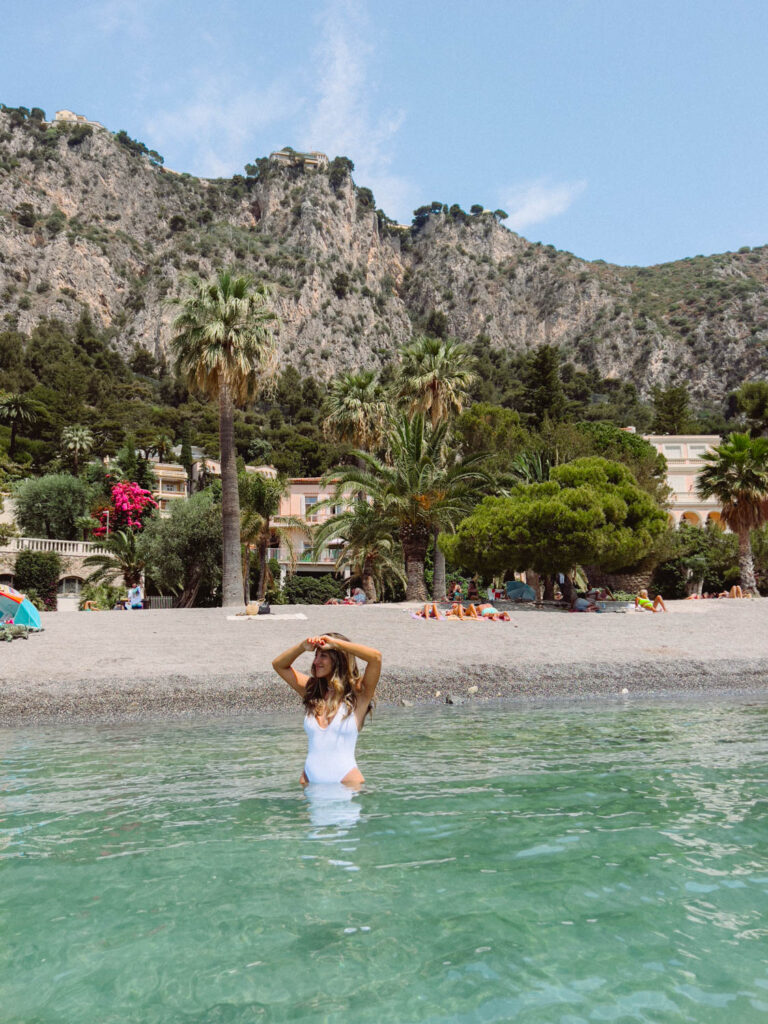 girl swimming at Petite Afrique beach on the french riviera 