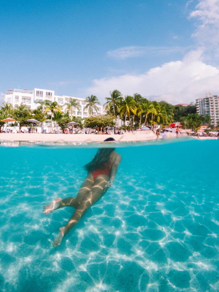 Adriana Maria swimming in blue turquoise water in montego bay jamaica