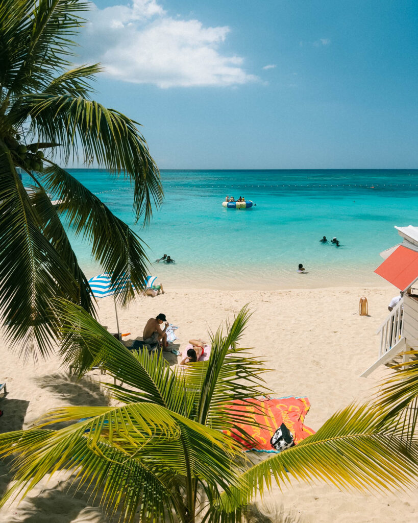 beach with coconut palms and turquoise Caribbean sea at doctors cave beach in montego bay jamaica