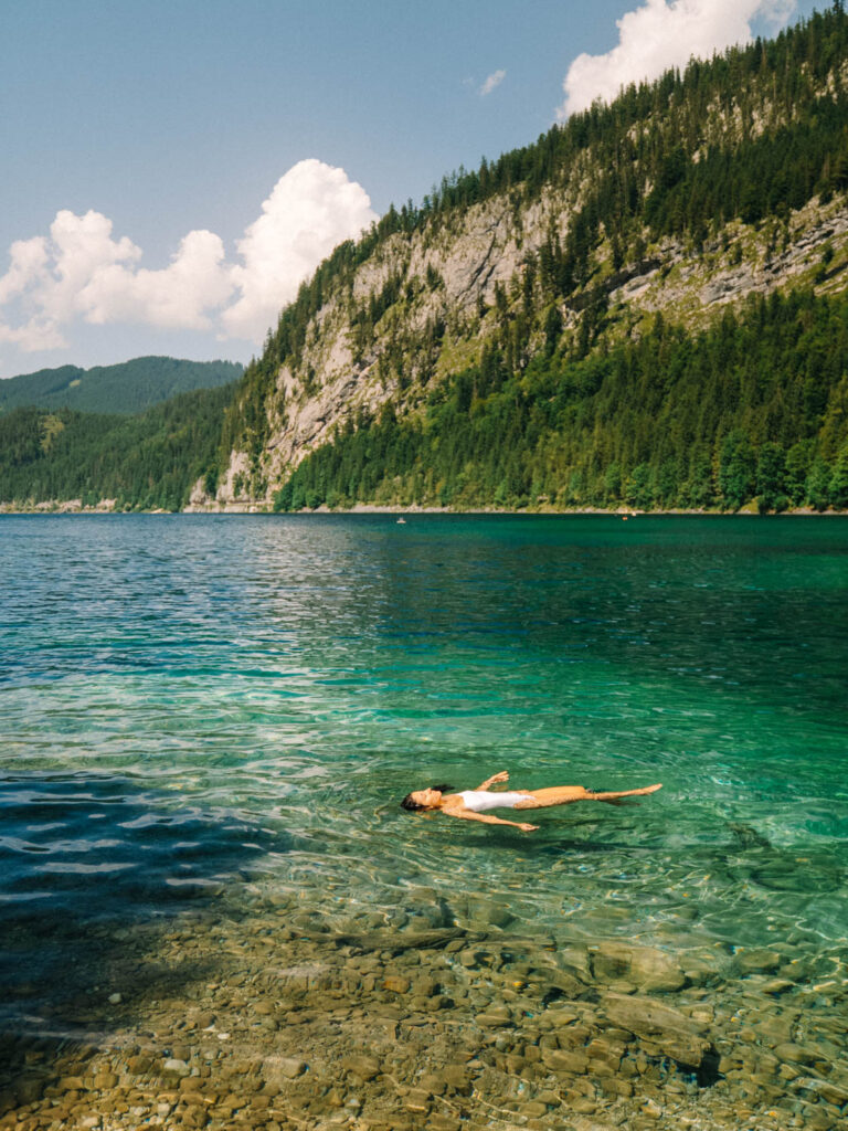 a woman swimming in the turquoise waters of Vorderer Gosausee austra 
