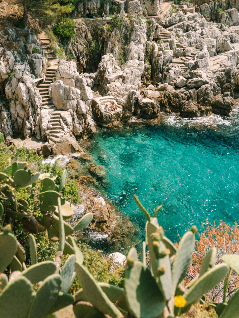 view of a turquoise blue water bay on the saint jean cap ferrat coastal walk 